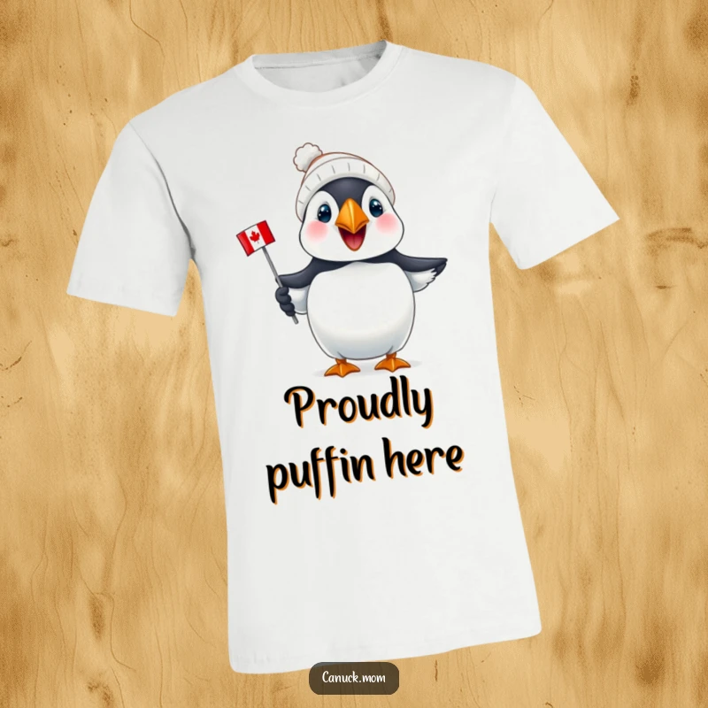 Funny Puffin Canada T-Shirt: A joyful puffin sports a tiny toque and holds a mini Canadian flag, exuding patriotic fun.