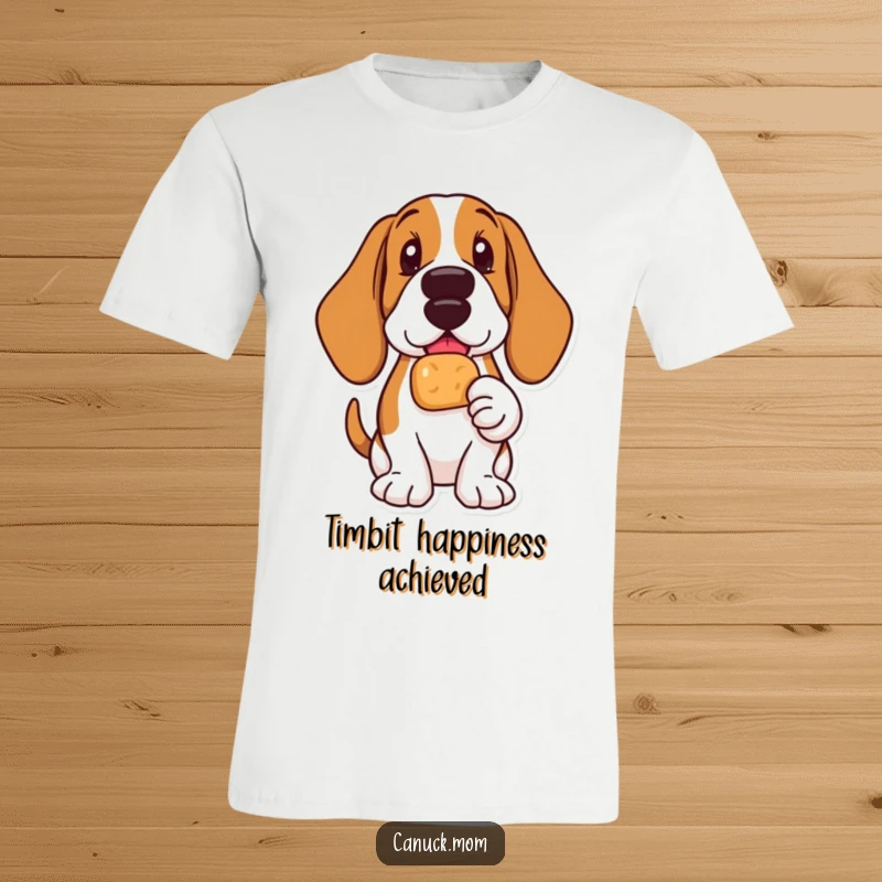 Funny Basset Hound t-shirt showing a delighted dog holding a Timbit, radiating pure happiness and snack joy.