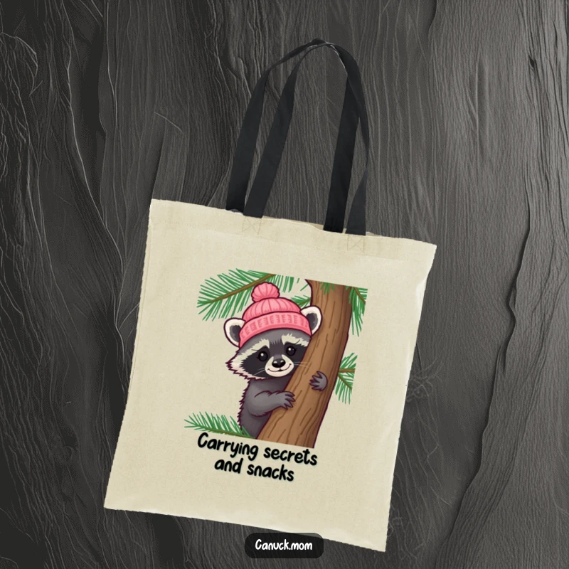 Funny Raccoon Hat Tote Bag: A curious raccoon in a tiny knitted hat peeks from behind a pine tree, perfect for carrying treasures.